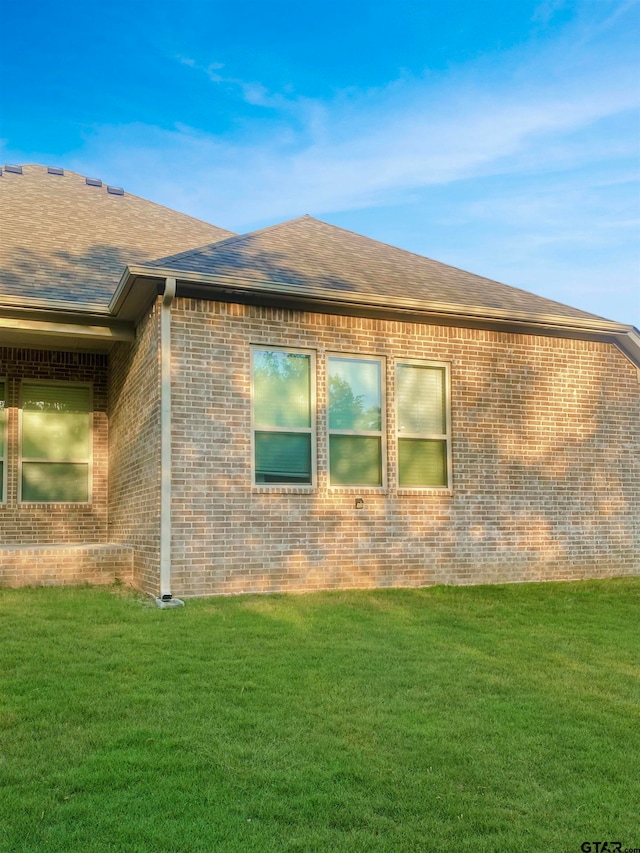 view of home's exterior with a lawn