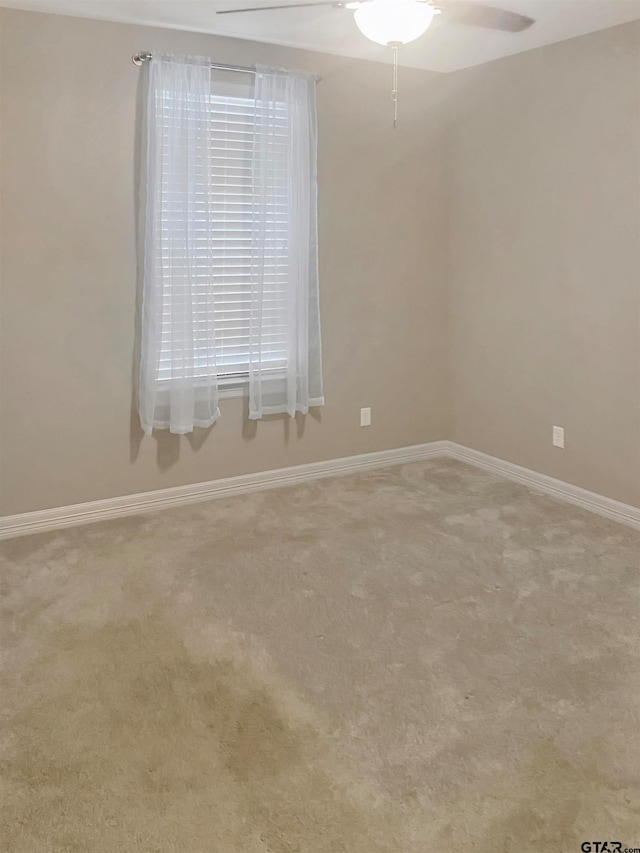 empty room with light carpet and ceiling fan