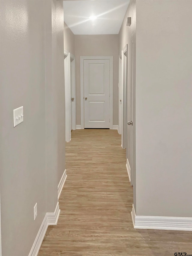 corridor with light wood-type flooring