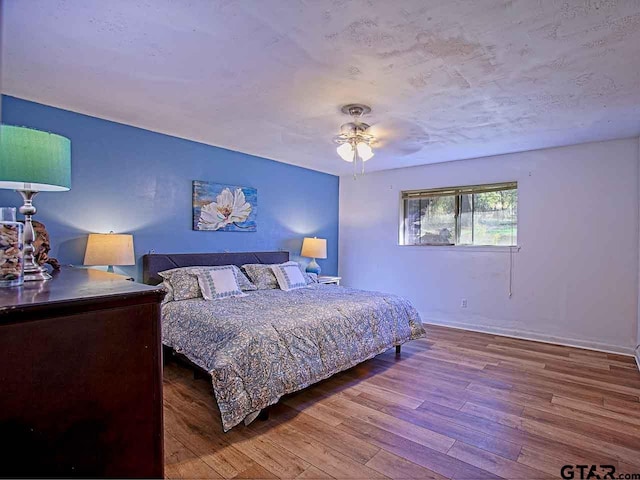 bedroom featuring hardwood / wood-style flooring and ceiling fan