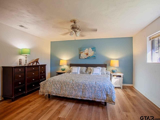 bedroom with ceiling fan and light hardwood / wood-style floors