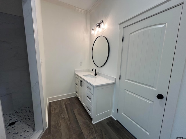 bathroom featuring vanity, hardwood / wood-style flooring, and crown molding