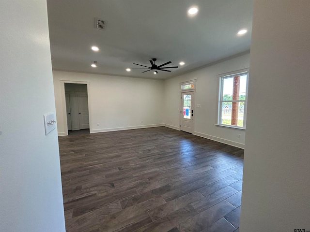 spare room featuring dark wood-type flooring and ceiling fan