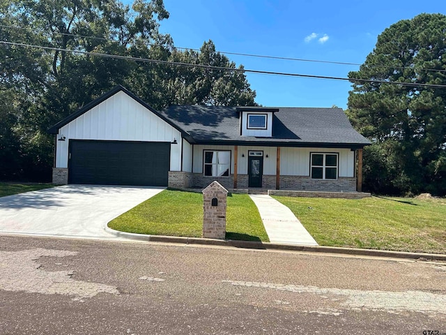 view of front of property featuring a garage and a front lawn