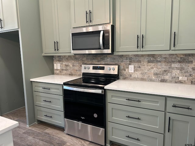 kitchen featuring decorative backsplash, dark hardwood / wood-style floors, and stainless steel appliances