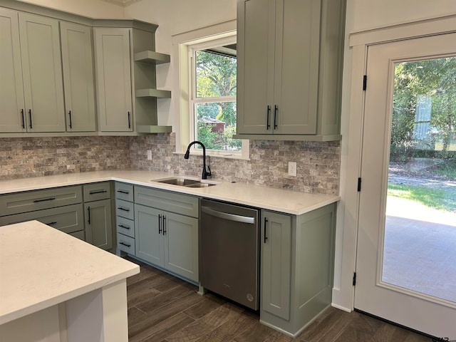 kitchen with stainless steel dishwasher, a healthy amount of sunlight, sink, and dark hardwood / wood-style flooring