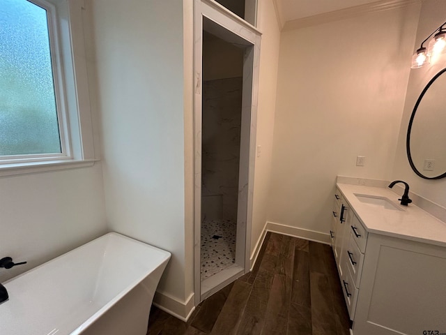 bathroom featuring hardwood / wood-style floors, vanity, and separate shower and tub