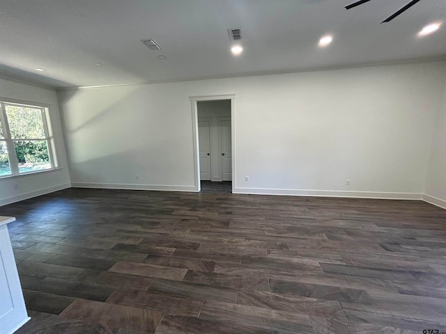 empty room featuring ceiling fan and dark hardwood / wood-style floors