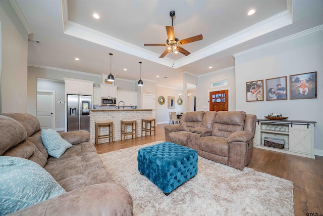 107 Hay Meadow Dr, Winona, TX 75792 - living room with a tray ceiling, dark wood-type flooring, a ceiling fan, recessed lighting, and crown molding
