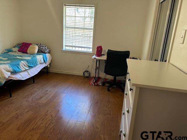 bedroom with wood finished floors