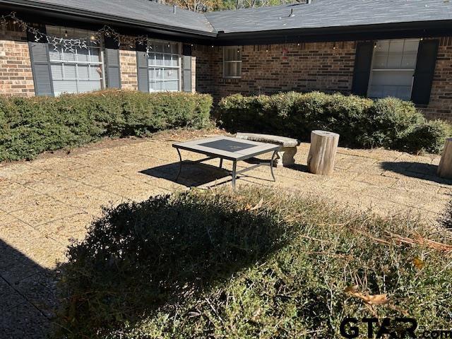 view of home's community with an attached garage and a patio area