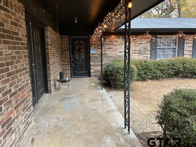 property entrance with brick siding