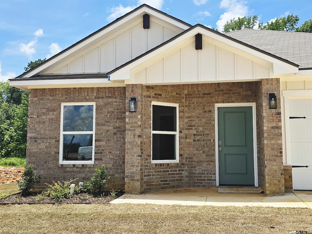 1106 Park Meadows Dr, Whitehouse, TX 75791 - view of front of house featuring board and batten siding, brick siding, and roof with shingles