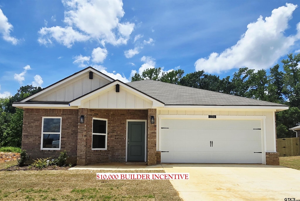 1106 Park Meadows Dr, Whitehouse, TX 75791 - view of front facade with brick siding, board and batten siding, an attached garage, concrete driveway, and roof with shingles