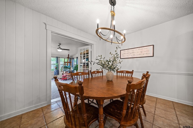 1430 Wavely St, Tyler, TX 75701 - dining room featuring a textured ceiling, a chandelier, a decorative wall, and ceiling fan