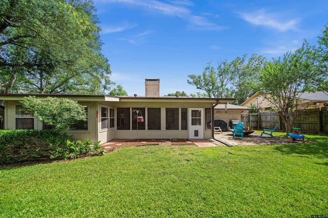 1430 Wavely St, Tyler, TX 75701 - rear view of house featuring a chimney, a sunroom, and a patio area
