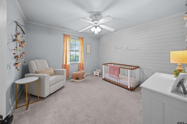 1430 Wavely St, Tyler, TX 75701 - bedroom featuring a nursery area, crown molding, carpet, ceiling fan, and wooden walls