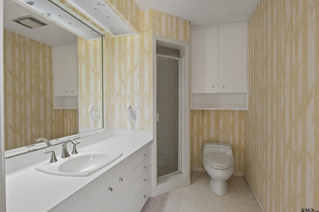 full bath with tile patterned floors, toilet, a stall shower, and vanity