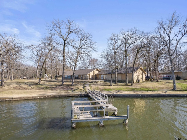 dock area featuring boat lift and a water view