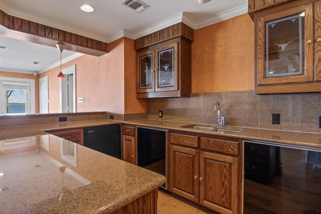 kitchen featuring visible vents, ornamental molding, a sink, brown cabinetry, and decorative backsplash