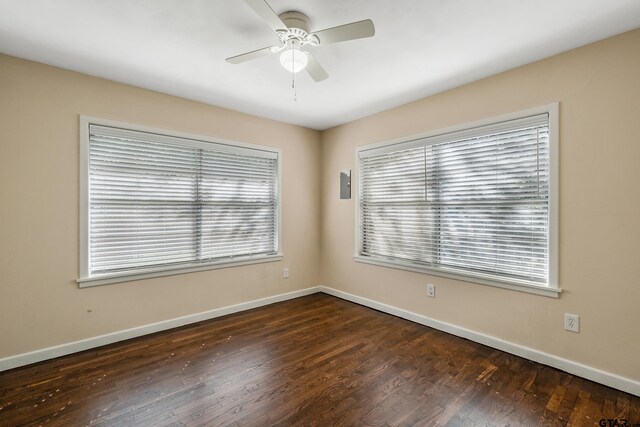 spare room featuring dark hardwood / wood-style flooring and ceiling fan