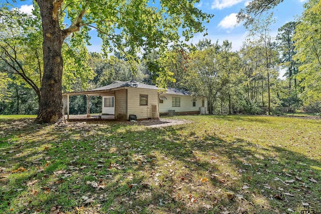 back of property with a lawn and a patio area