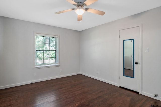 empty room featuring ceiling fan and dark hardwood / wood-style floors