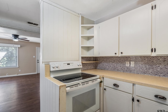 kitchen with dark hardwood / wood-style flooring, backsplash, white cabinets, and electric range