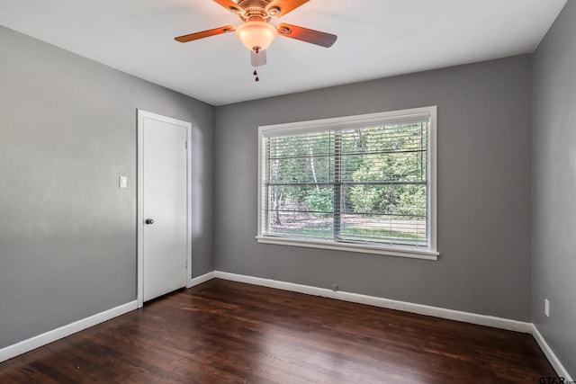 empty room featuring ceiling fan and dark hardwood / wood-style floors