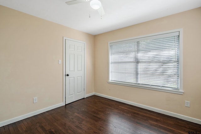 spare room featuring dark hardwood / wood-style floors and ceiling fan