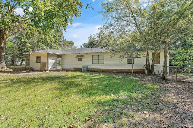 back of house with a lawn and central AC