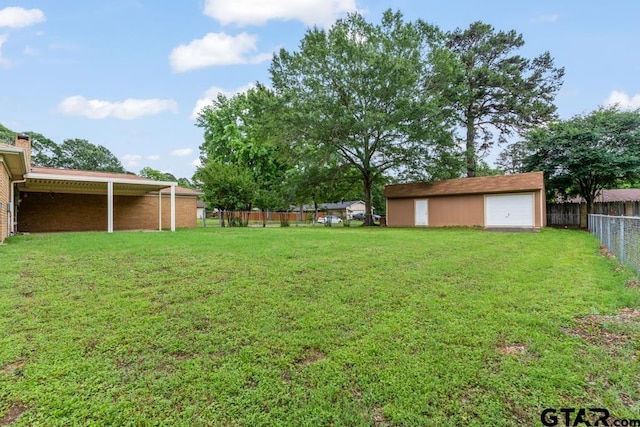 901 Dogwood St, Gilmer, TX 75644 - view of yard with a garage and an outdoor structure