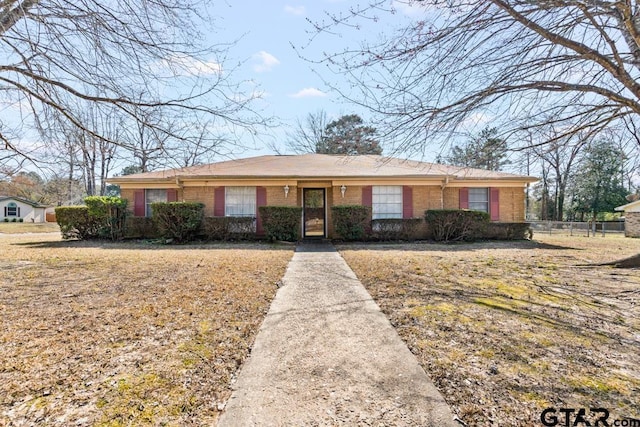 view of front facade with fence and brick siding