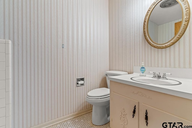 901 Dogwood St, Gilmer, TX 75644 - bathroom featuring wallpapered walls, tile patterned floors, vanity, toilet, and baseboards