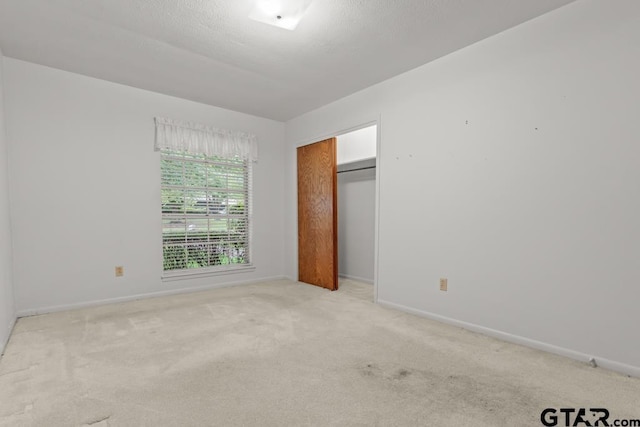 901 Dogwood St, Gilmer, TX 75644 - unfurnished bedroom featuring baseboards, carpet flooring, and a closet