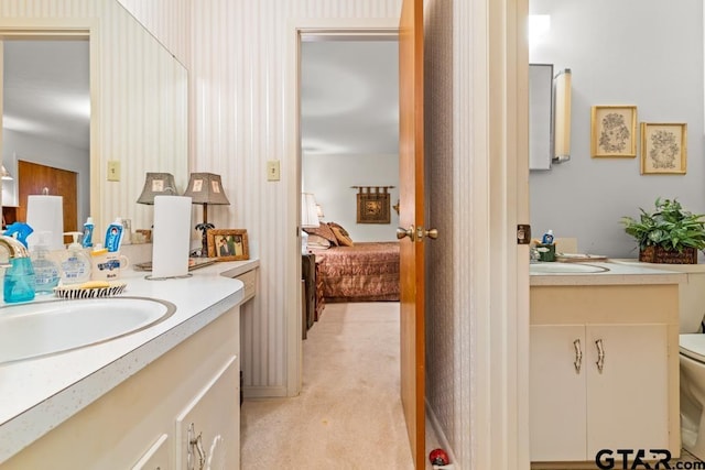 full bath featuring connected bathroom, vanity, and toilet