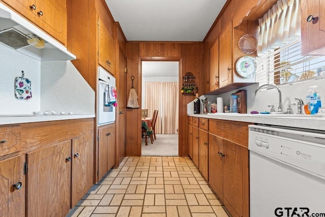 kitchen with brown cabinets, light countertops, and dishwasher