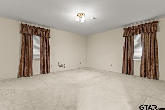 901 Dogwood St, Gilmer, TX 75644 - empty room featuring healthy amount of natural light, carpet flooring, and baseboards