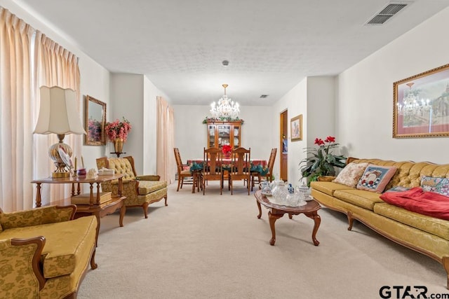 carpeted living room with a healthy amount of sunlight, visible vents, and a notable chandelier