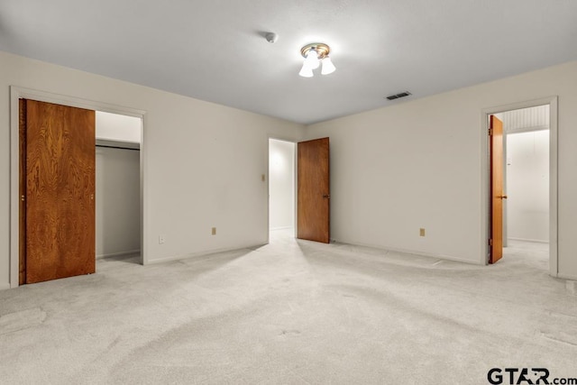 901 Dogwood St, Gilmer, TX 75644 - unfurnished bedroom featuring light carpet, baseboards, and a closet