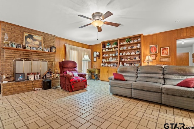 living area with brick floor, ceiling fan, and wooden walls