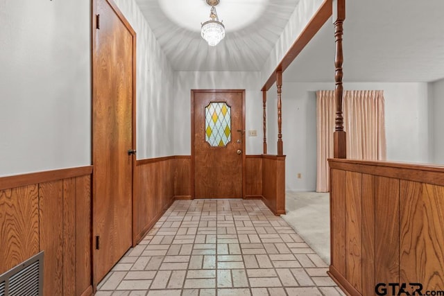 901 Dogwood St, Gilmer, TX 75644 - entrance foyer with a wainscoted wall, wood walls, and brick patterned flooring