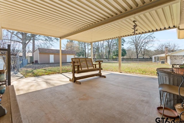 view of patio featuring a fenced backyard, a shed, and an outbuilding