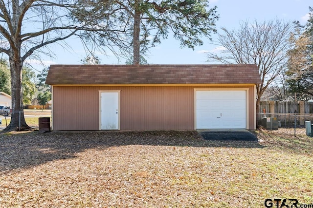 garage featuring fence and central air condition unit