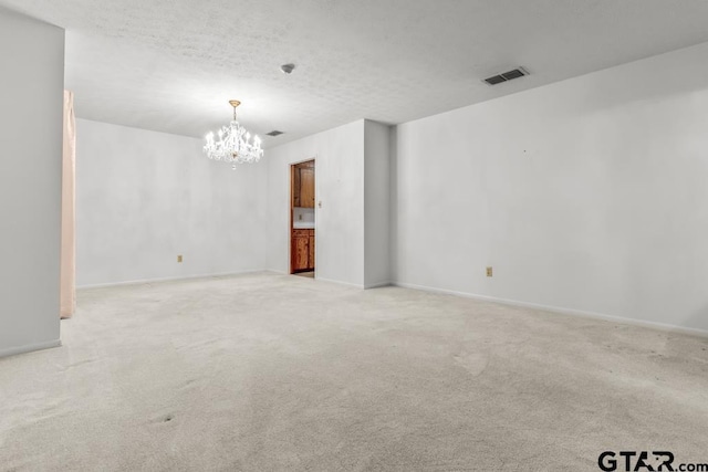 901 Dogwood St, Gilmer, TX 75644 - unfurnished room featuring a chandelier, carpet flooring, and baseboards