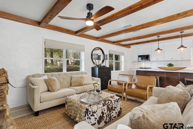 11020 Kevin Dr, Frankston, TX 75763 - living room with beamed ceiling, ceiling fan, light wood-type flooring, and baseboards