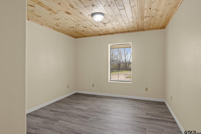 2106 Fm 1647, Winnsboro, TX 75494 - empty room featuring wooden ceiling, baseboards, and wood finished floors