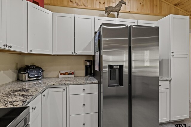 2106 Fm 1647, Winnsboro, TX 75494 - kitchen with white cabinetry, light stone counters, and stainless steel appliances