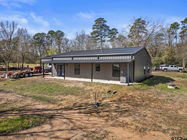2106 Fm 1647, Winnsboro, TX 75494 - rear view of property featuring cooling unit, french doors, metal roof, and a standing seam roof
