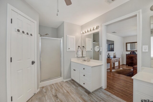 1650 Vz County Road 2512, Canton, TX 75103 - bathroom featuring wood finished floors, a shower stall, vanity, and ceiling fan